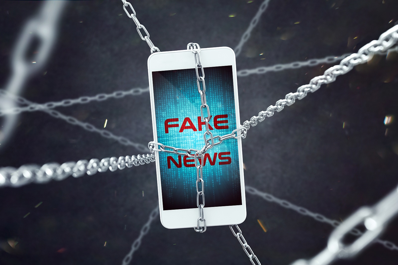 Smartphone with fake news inscription in chains. Conception of increasing problem of fake news.