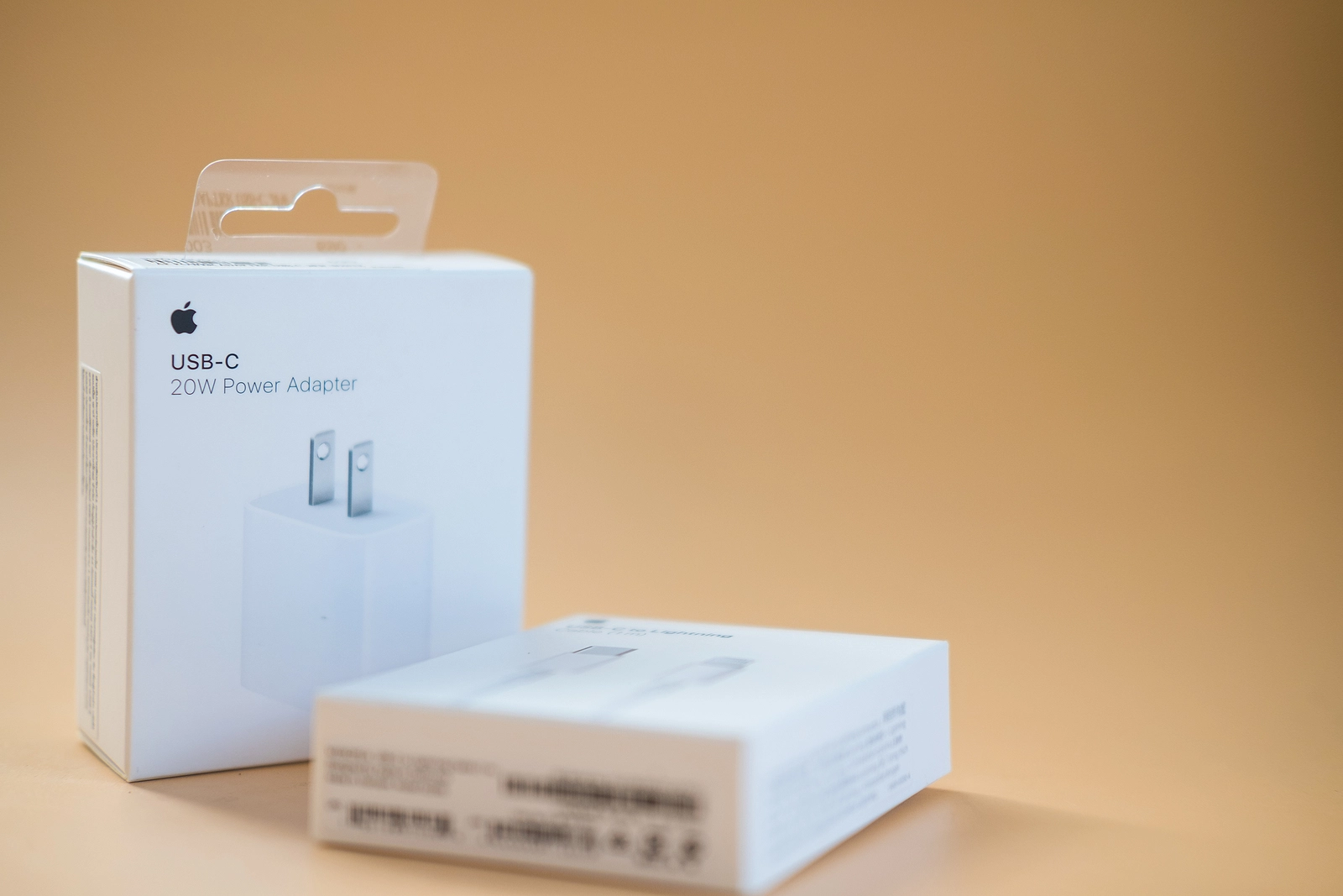 Bangkok - January 16, 2022 : A box of High power USB-C power adapter 20w by Apple on a orange surface with copy space