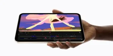 Das iPad mini A20 Pro in Polarstern liegt quer in einer Hand und zeigt eine Animations-App