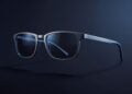 Conceptual image of smart glasses with a slim titanium frame and tinted lenses in three-quarter view