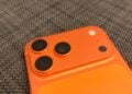 Camera plateau of an iPhone 17 Pro Max in Cosmic Orange, whose image sensor carries the provenance data for Apple Reference Image