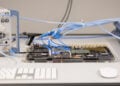 Symbolic image for Apple China memory: test setup with circuit board and analyzer at Apple's Silicon Design Center in Munich