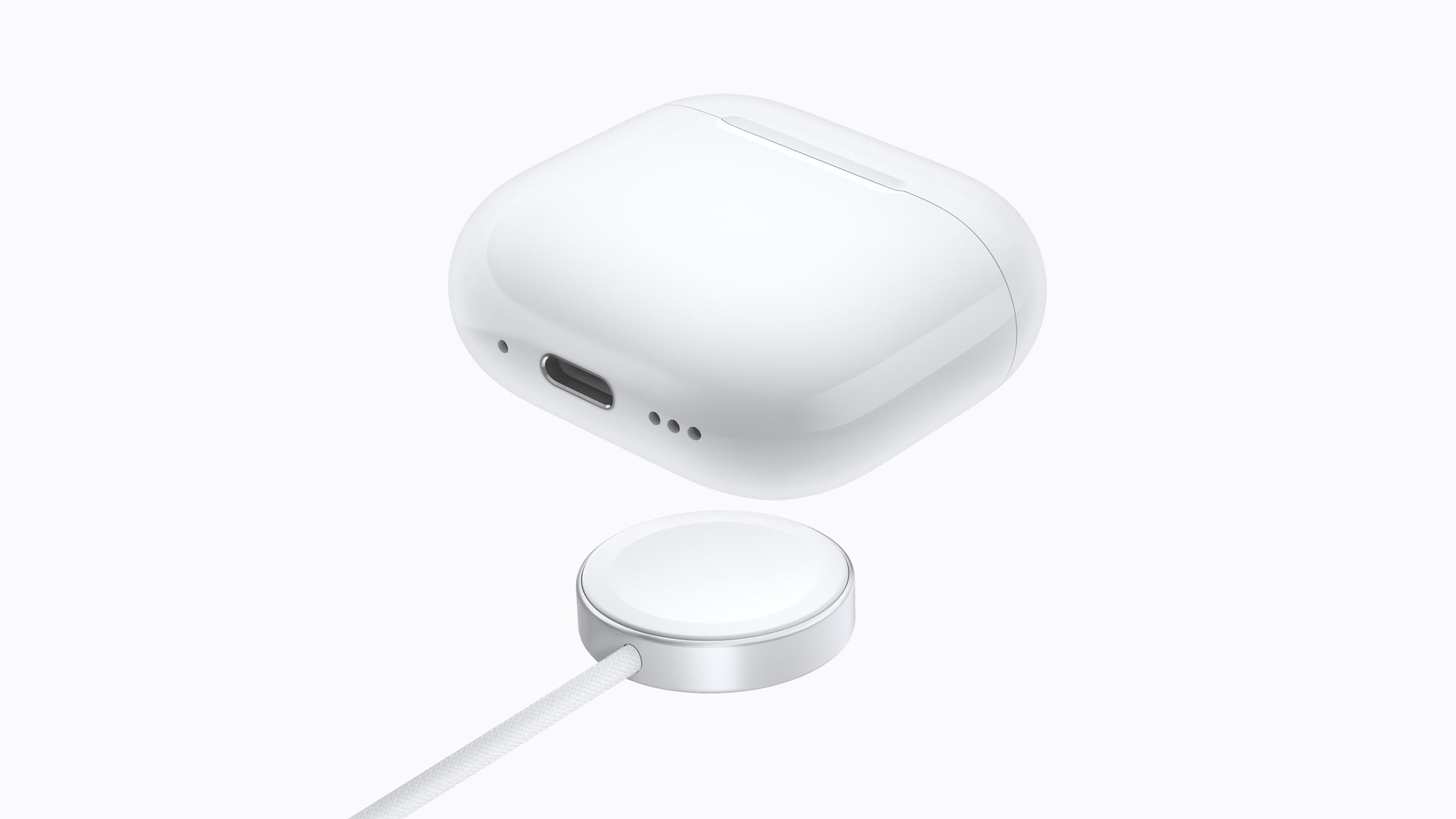 AirPods 5 charging case above an Apple Watch charger, with the USB-C port visible on the case