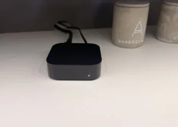 Apple TV 4K A19: schwarze Apple-TV-Box mit leuchtender Statusanzeige auf einer hellen Ablage