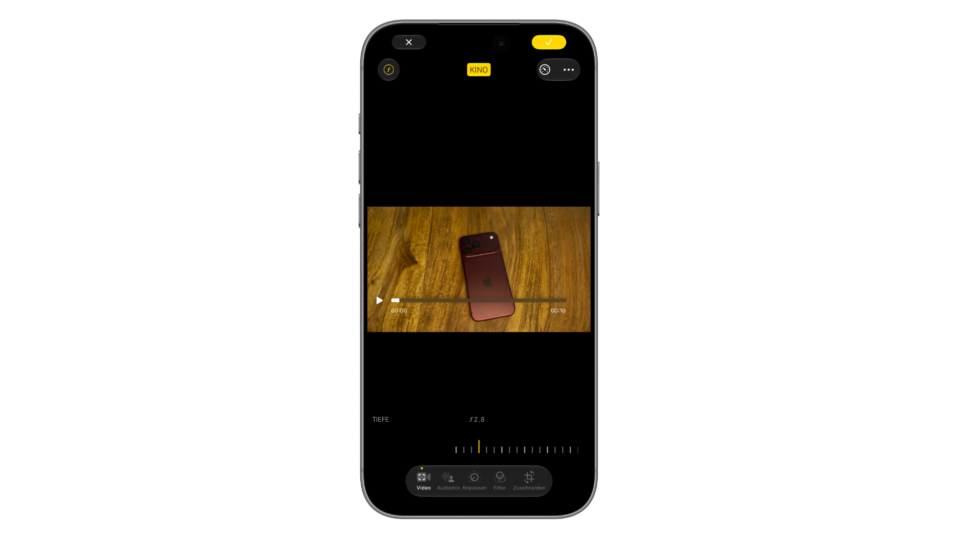 iPhone mockup of the Photos app: the Cinematic button is active on a regular video, with a slider below for adjusting the depth effect by ƒ-number
