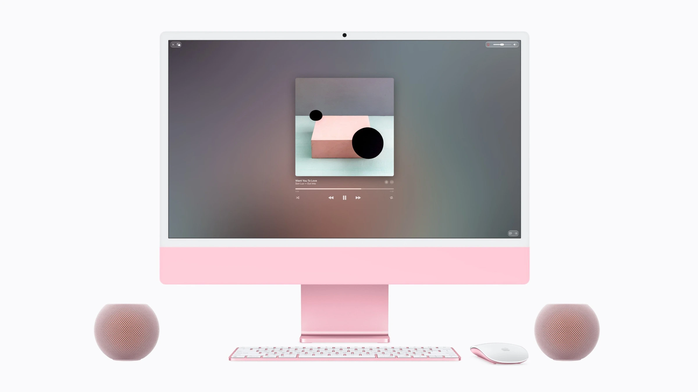 Apple Event Welcome home: zwei HomePod mini in Rosa als Lautsprecher links und rechts neben einem rosafarbenen iMac, auf dem Musik läuft
