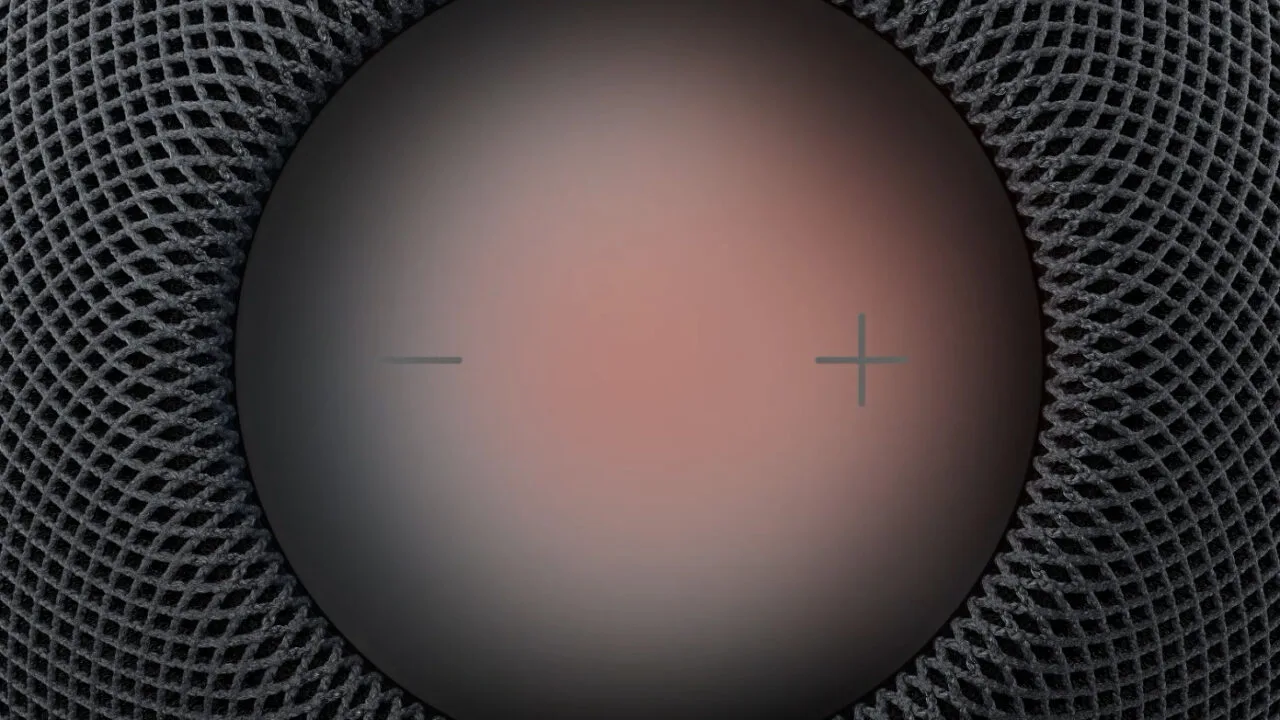 HomePod Sound Glow: Oberseite eines HomePod mit rötlich leuchtender Touch-Fläche, Plus- und Minus-Symbol und dunklem Gewebe ringsum