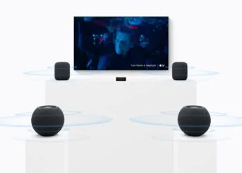 HomePod Surround Einstellungen: zwei große HomePods neben einem Fernseher, davor zwei HomePod mini auf Sockeln und ein Apple TV in der Mitte