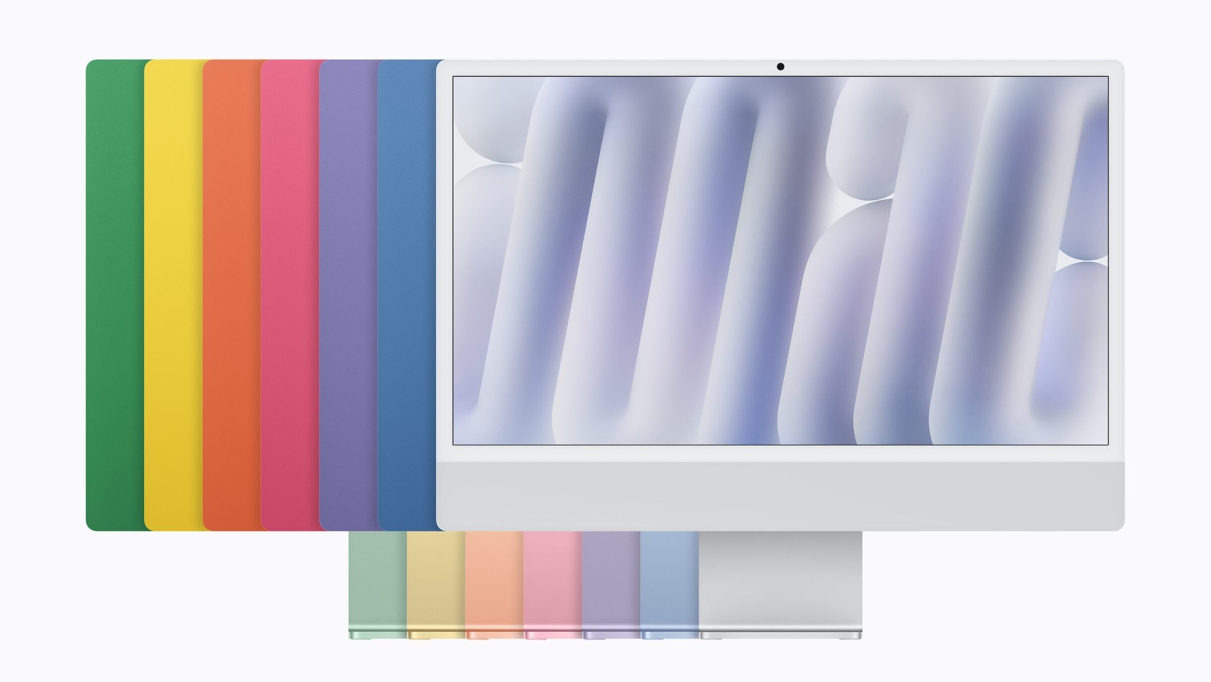 iMac M6 in silver from the front, with the backs in blue, purple, pink, orange, yellow and green behind it