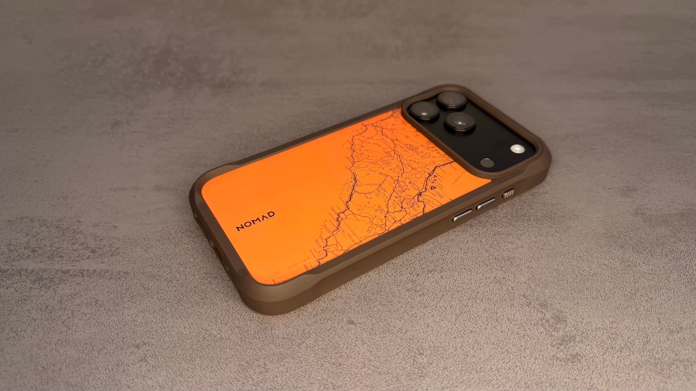 Nomad cases iPhone 18 Pro: Rugged Case in Arroyo with an orange back plate, engraved map and reinforced corners