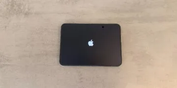 iPhone Duo Rückruf: aufgeklapptes iPhone Duo liegt flach auf einem grauen Tisch, das Innendisplay zeigt beim Start das Apple-Logo