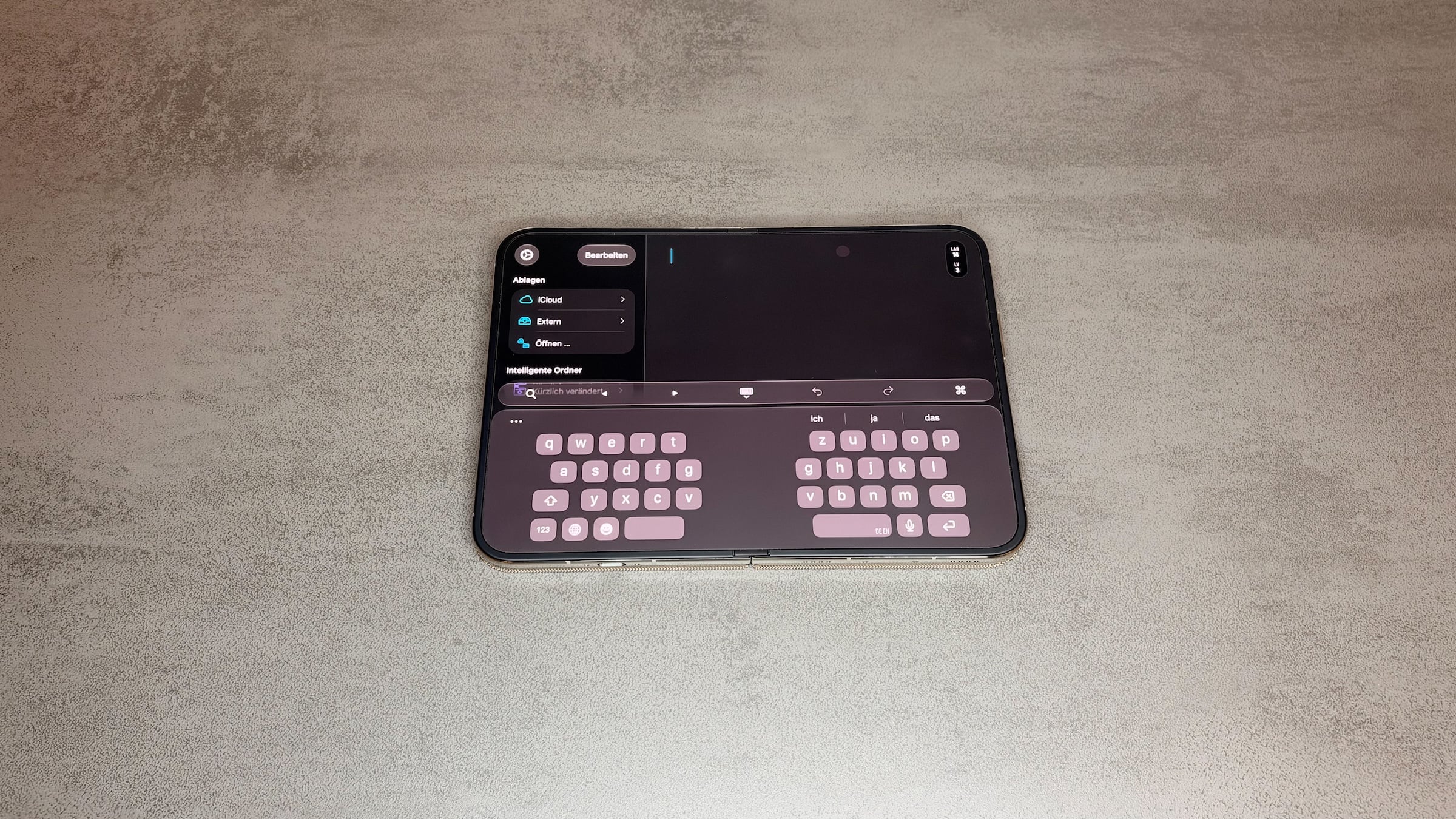 iPhone Duo unfolded in landscape with the split keyboard on the inner display, a highlight of the first impression