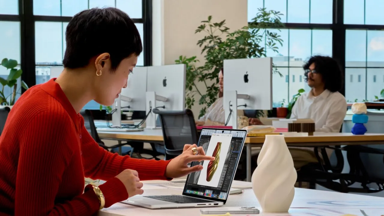 MacBook Pro Touch: Eine Frau tippt auf das Display eines MacBook Pro und bearbeitet dort das 3D-Modell einer Vase